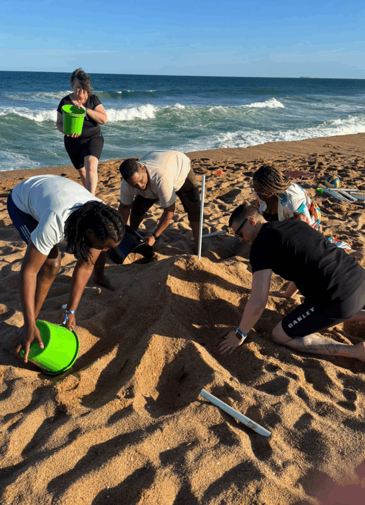 Corporate team working together during TVG's Beach Challenge designed to strengthen strategy and collaboration.